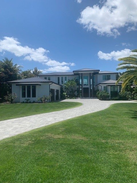Modern two-story residence seen across a wide lawn
