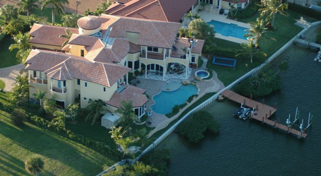 Aerial view of the property, pool and dock