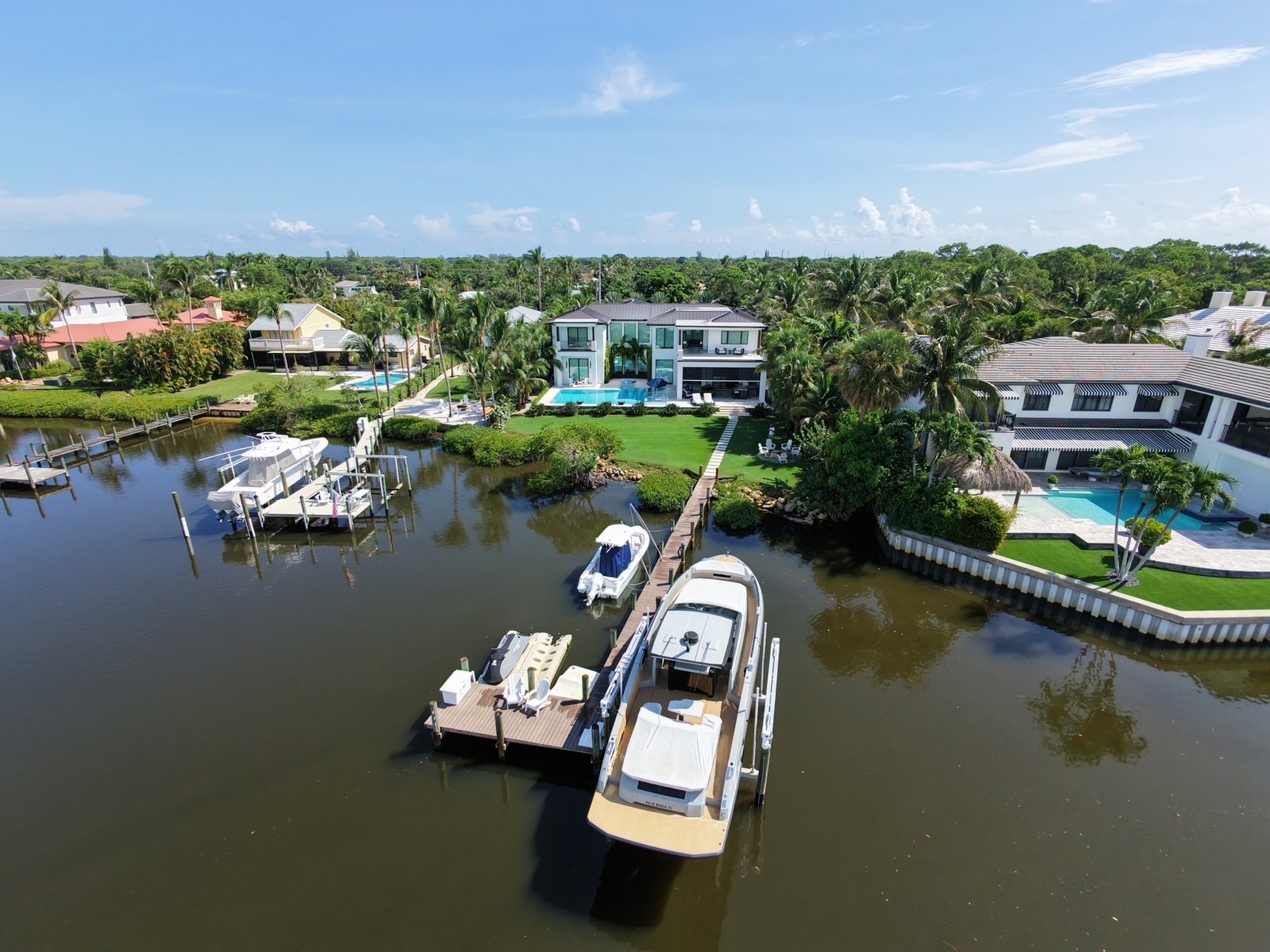 Aerial view of the DeLange estate on the water with pool and boat dock