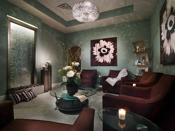 Lounge with a backlit water wall and upholstered seating