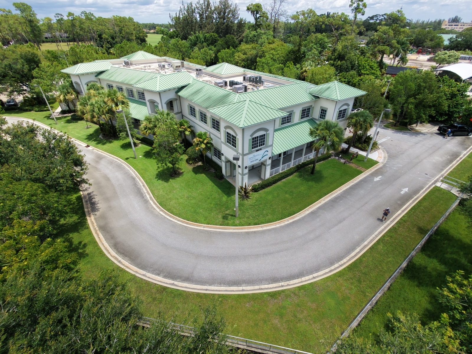 Aerial view of a two-story medical office building with a green metal roof