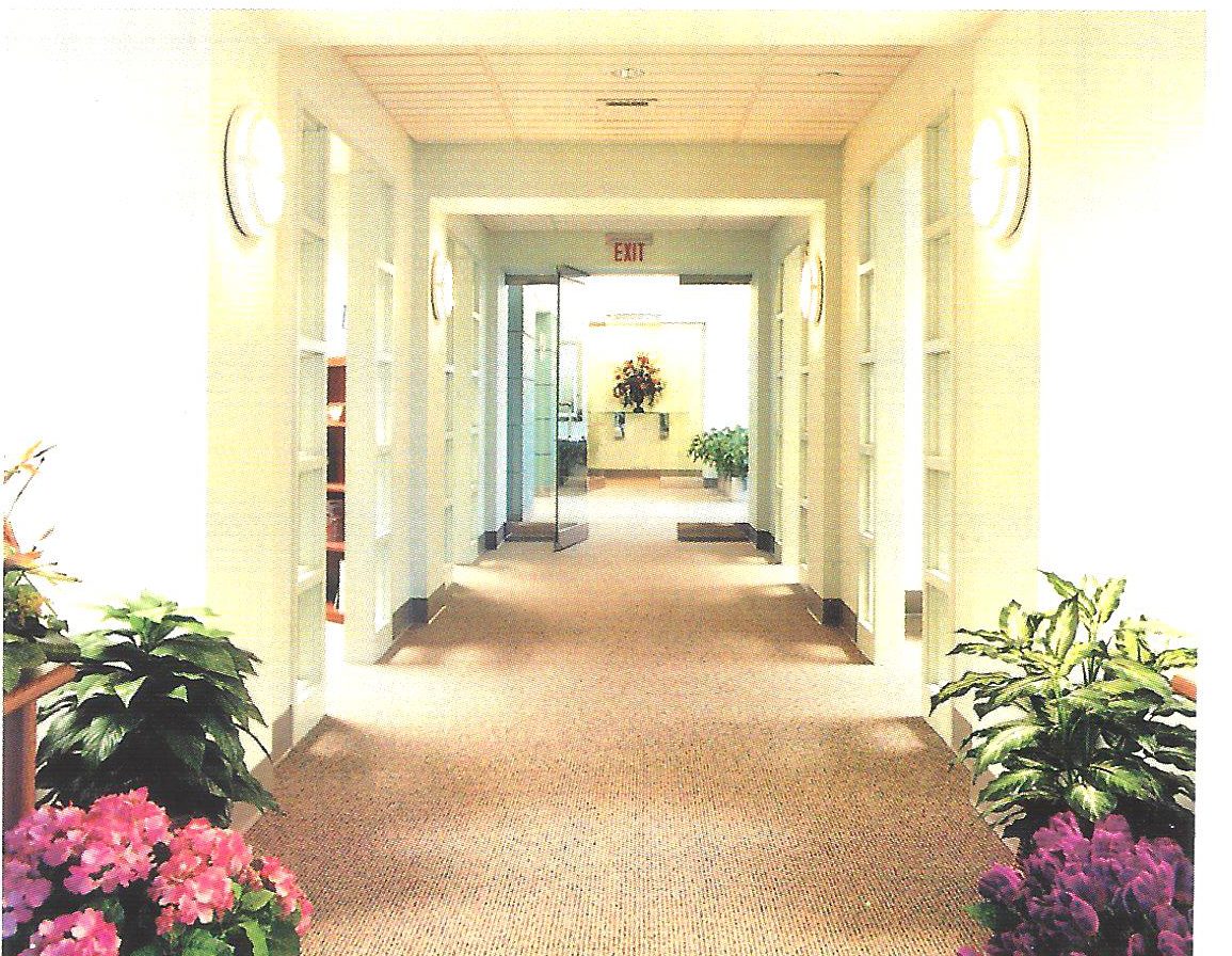 Arched interior walkway with sconces and potted flowers at Homesource Capital