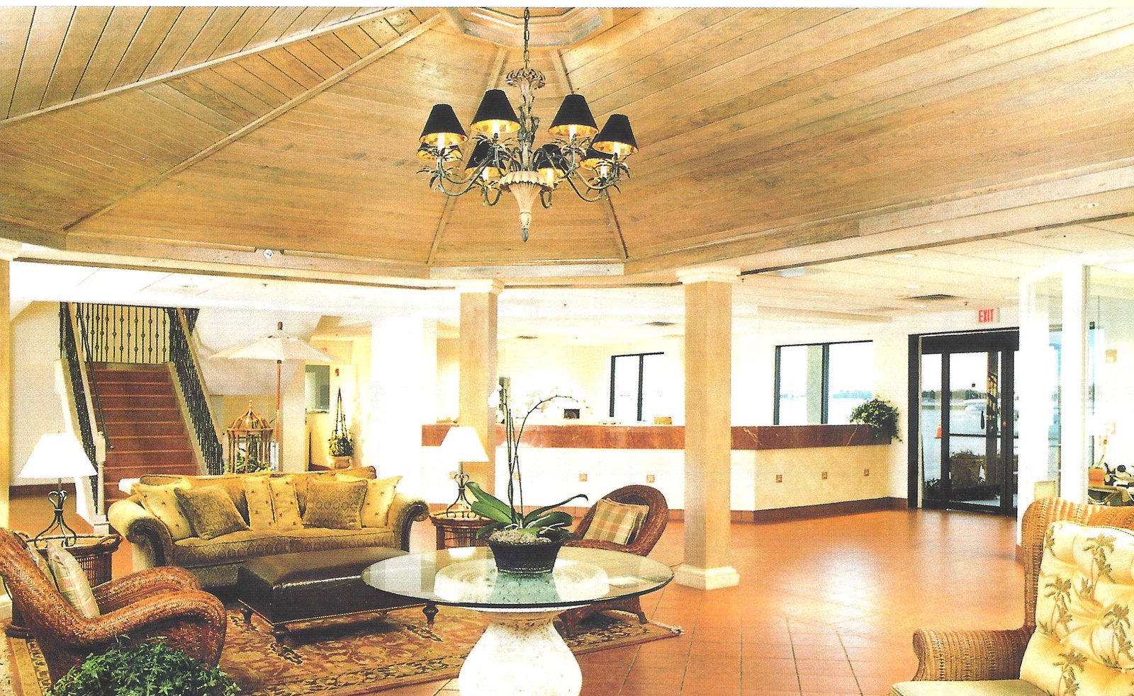 Wood-ceilinged lobby with wicker seating and a chandelier at Jet Aviation's terminal