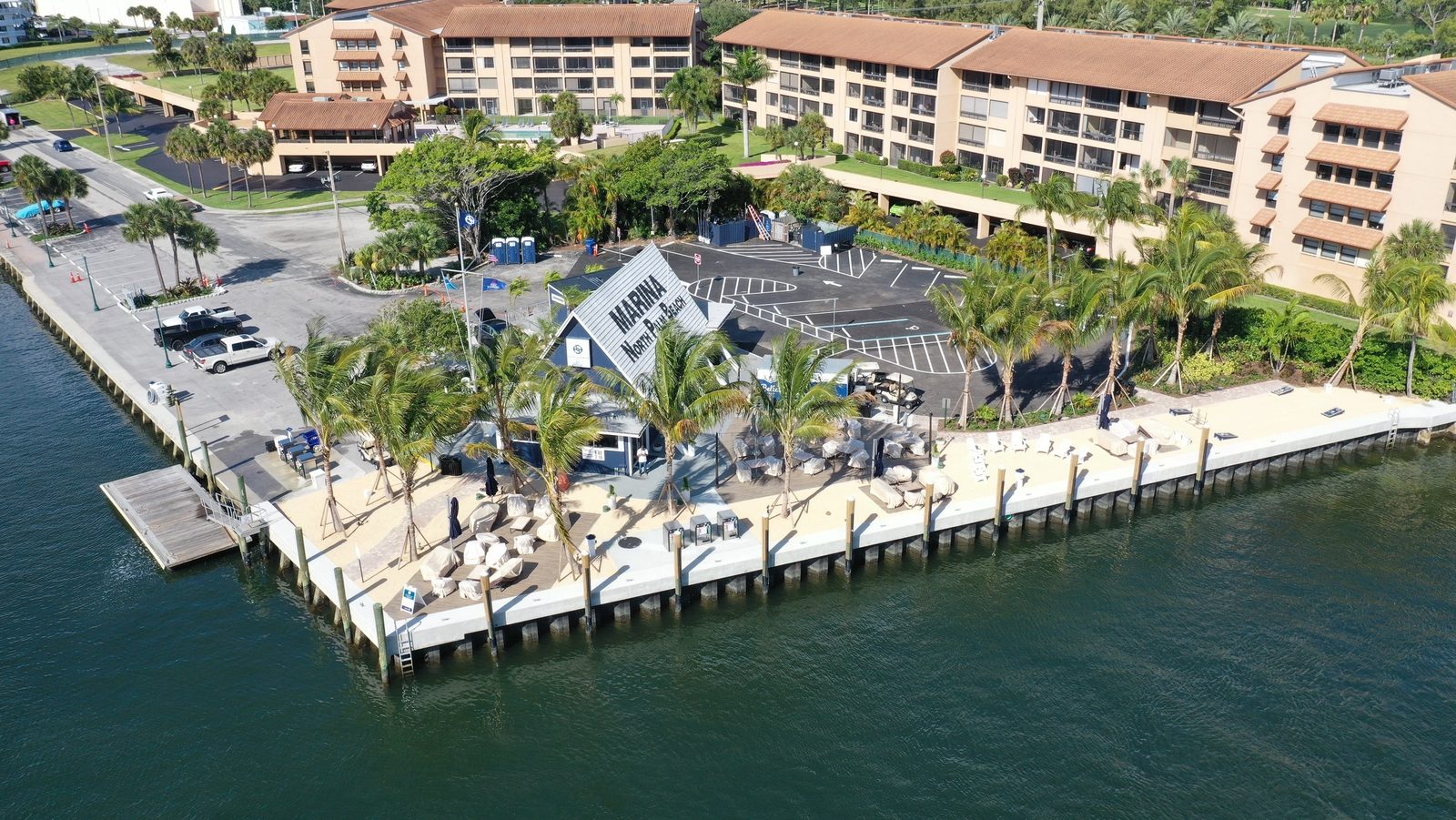 Aerial view of North Palm Beach Marina with docks, boats and waterfront buildings