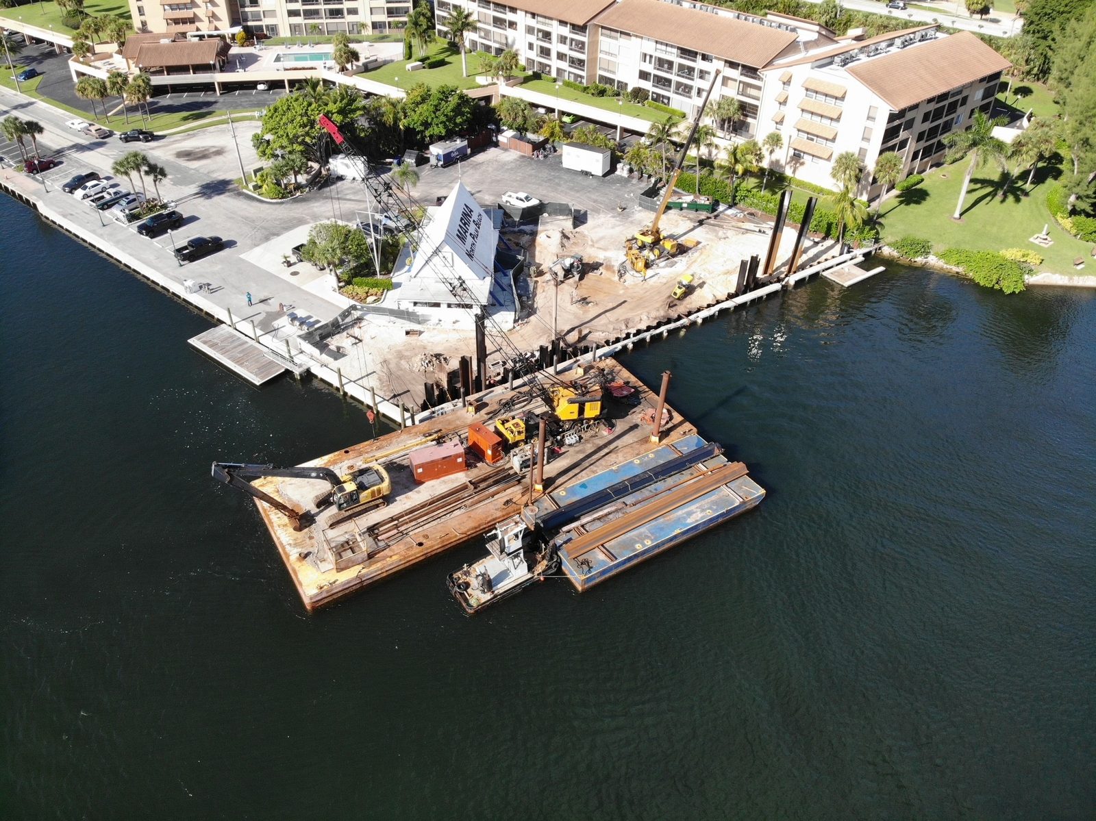 Barges and pile driving rigs working alongside the seawall during construction