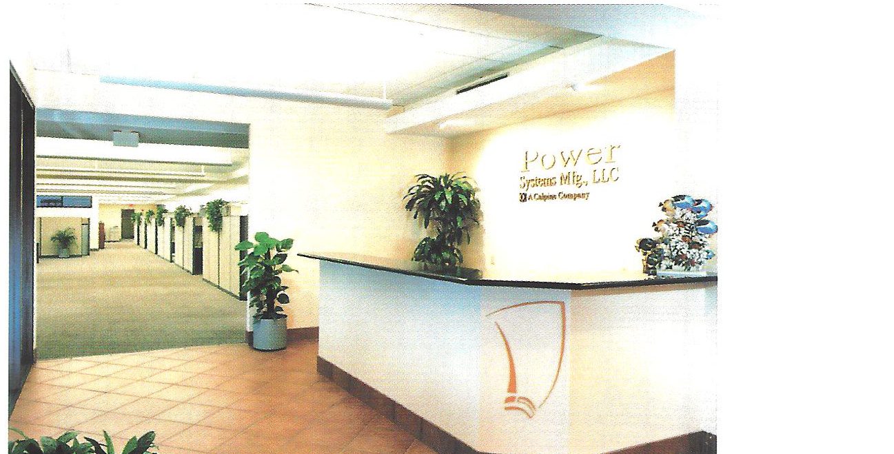 Reception area with curved desk and company sign at Power Systems Manufacturing