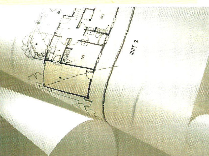 Rolled construction drawings opened on a table